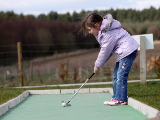girl playing crazy golf